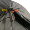 Close-up of a grey-green tent apex where a black trekking pole with foam grip and wrist strap props open the fly, secured by an orange fabric tab and knotted yellow guy lines.