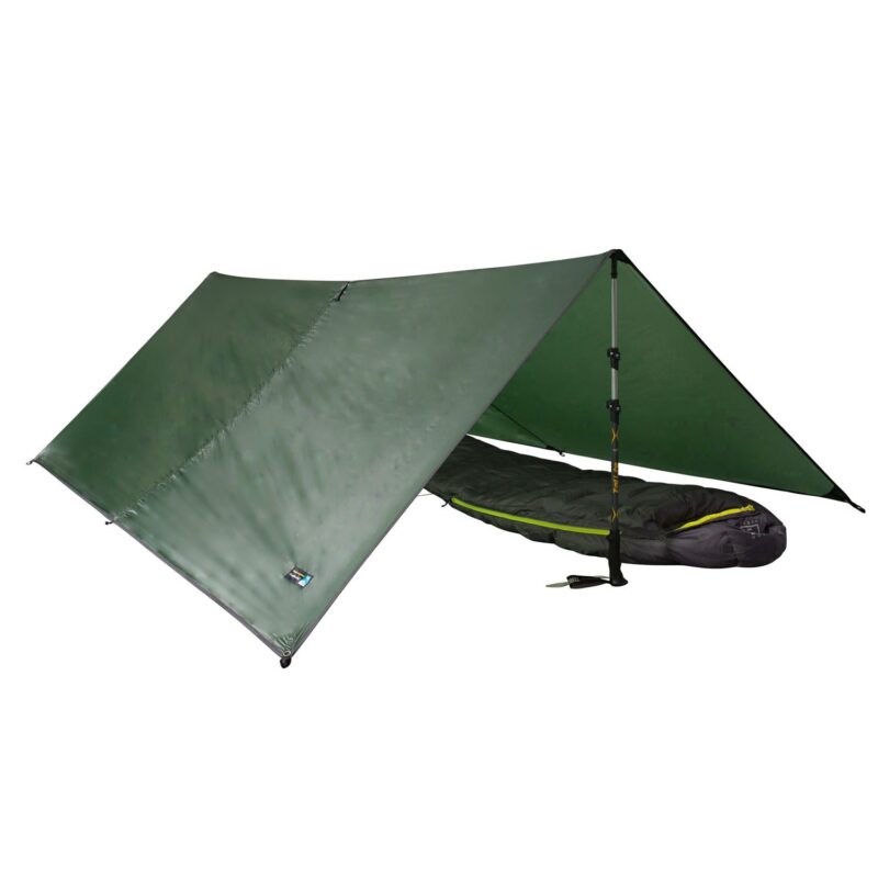 Green A‑frame tarp shelter pitched with an adjustable trekking pole holding up one side and a black sleeping bag with yellow trim laid underneath on a white background.