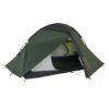Green two-person dome camping tent with dark grey flysheet partially opened to show a mesh inner compartment and black bathtub-style floor, supported by coloured poles and yellow guy lines on a white background.