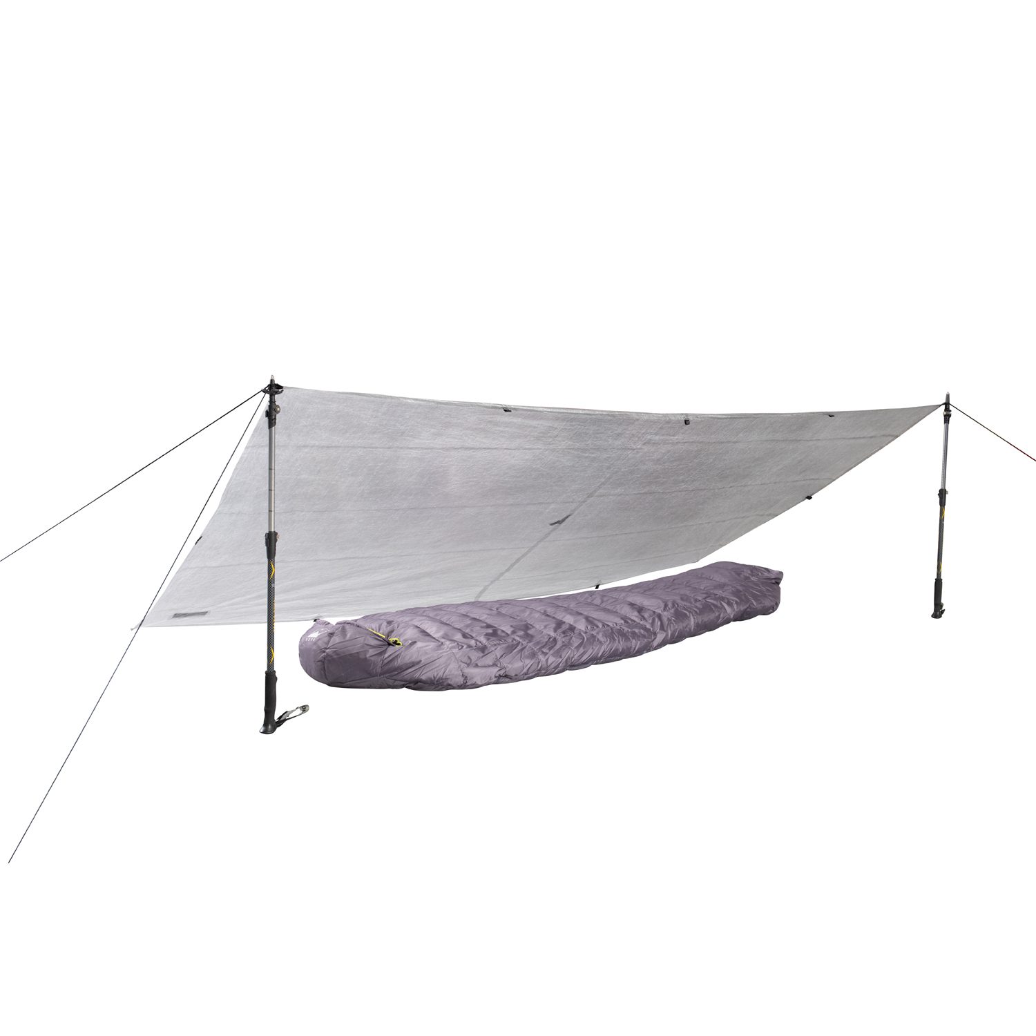Silver emergency tarp pitched as a low shelter using two adjustable trekking poles and guylines, covering a purple mummy-style sleeping bag beneath.