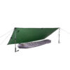 Green tarp pitched as an A-frame using two trekking poles and guy lines, sheltering a grey mummy-style sleeping bag on a white background.