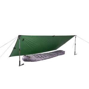 Green tarp pitched as an A-frame using two trekking poles and guy lines, sheltering a grey mummy-style sleeping bag on a white background.