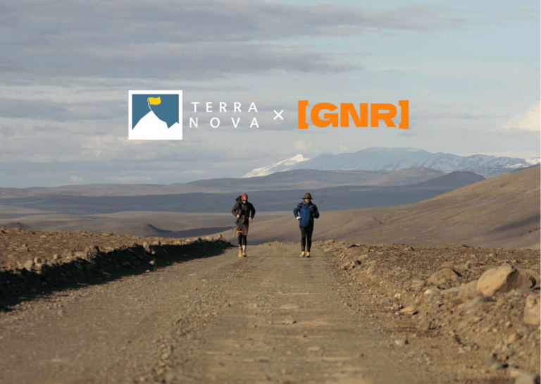 Two runners on a rugged dirt path in a scenic landscape, featuring mountains in the background, showcasing a collaboration between Terra Nova and GNR.