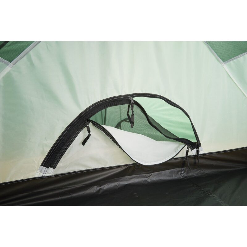 Interior of a pale green tent showing a semi-circular zippered ventilation window with black mesh and a partially opened white fabric cover above a black groundsheet.
