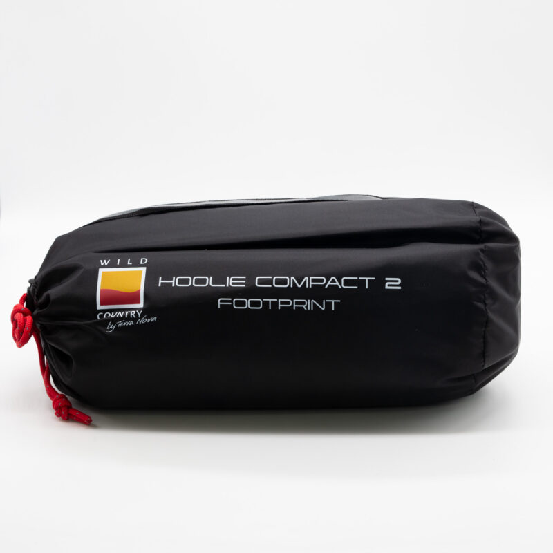 Black cylindrical storage bag with a red drawcord, printed white text reading "Hoolie Compact 2 Footprint" and a small Wild Country logo, photographed on a plain white background.