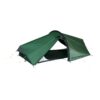 Low-profile dark green two-person tunnel tent with black trim and single arched pole, partially open doorway revealing the black inner groundsheet and secured with yellow guy lines on a white background.