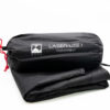 Black Terra Nova Laser Lite 1 footprint in a cylindrical stuff sack with red drawcord, labeled with the Terra Nova logo and resting on a folded black groundsheet against a white background.