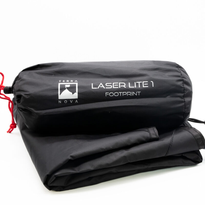 Black Terra Nova Laser Lite 1 footprint in a cylindrical stuff sack with red drawcord, labeled with the Terra Nova logo and resting on a folded black groundsheet against a white background.