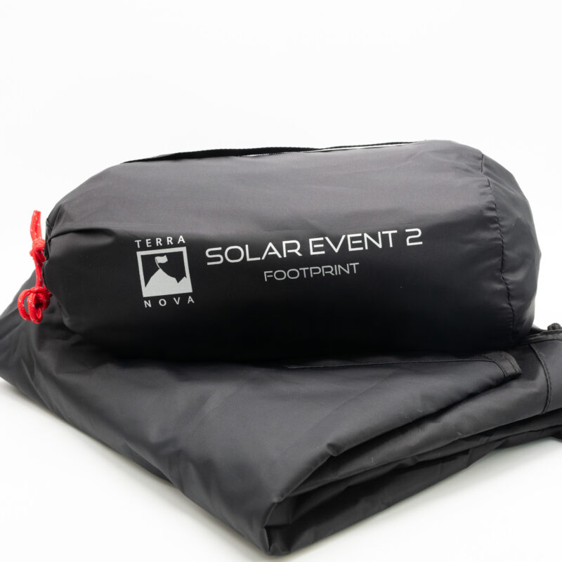 Black roll-up bag and folded footprint fabric printed with the Terra Nova logo and the text “SOLAR EVENT 2 FOOTPRINT,” with a red drawcord, on a white background