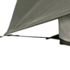 Close-up of a grey tent fly corner secured by a black webbing strap and yellow guyline to the tent base.