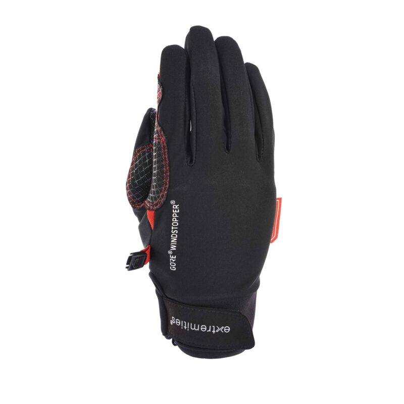 Black GORE® Windstopper glove with red accents and textured grip patches on the thumb and palm, Velcro wrist strap showing 'extremities' branding, photographed flat on a white background.