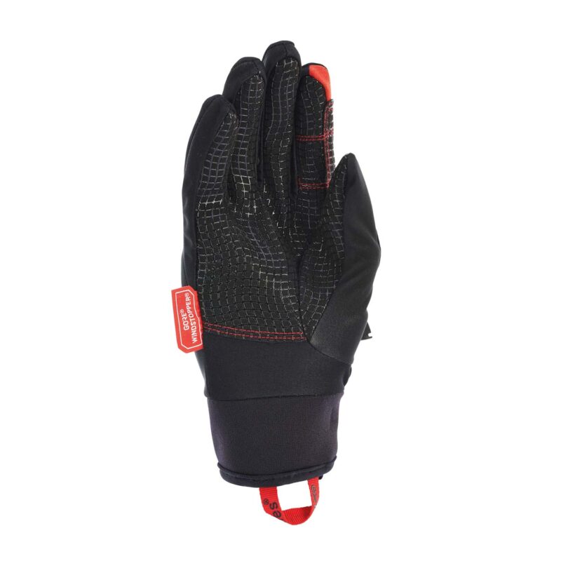 Black insulated glove shown palm-up with a textured grid grip on the palm, red stitching and fingertip patch, and a red pull loop and tag at the cuff