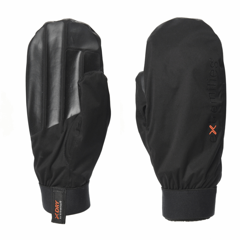 Pair of black waterproof mittens shown side-by-side, left mitten palm-facing with three molded rubber grip ridges and a small XDRY fabric pull tab at the wrist, right mitten back-facing with a vertical extremities logo and orange 'x' detail.
