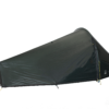 Low-profile single-person dark green/black backpacking tent with a tapered, aerodynamic tunnel shape and a peaked right-side entrance featuring a vertical zip and yellow guy lines, shown against a plain dark background.