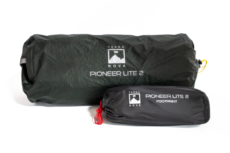 Dark green rolled tent bag labeled Terra Nova Pioneer Lite 2 alongside a smaller black stuff sack marked Pioneer Lite 2 Footprint with a red cord pull.
