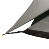 Close-up of a grey tent rainfly corner with a black hem and a taut yellow guyline clipped to a black strap and tensioner.