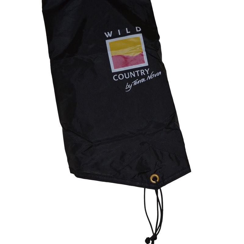 Black nylon stuff sack with 'WILD COUNTRY by Terra Nova' logo featuring a yellow-and-pink square, plus a brass grommet and drawstring at the corner.
